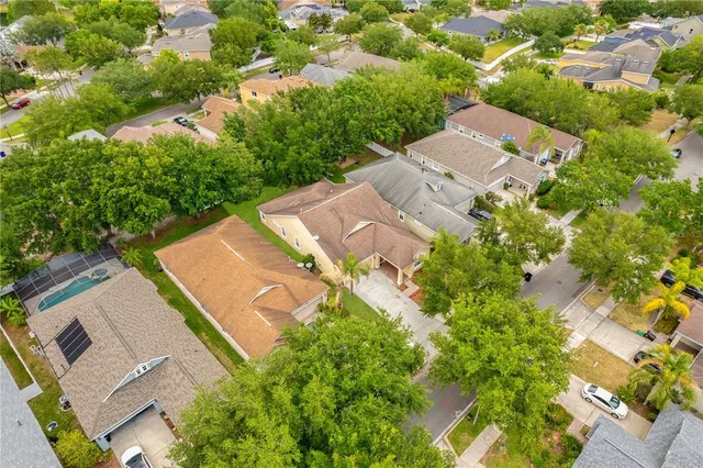 an aerial view of residential houses with outdoor space and street view