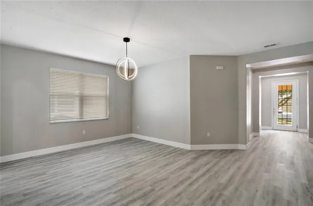 a view of a room with wooden floor