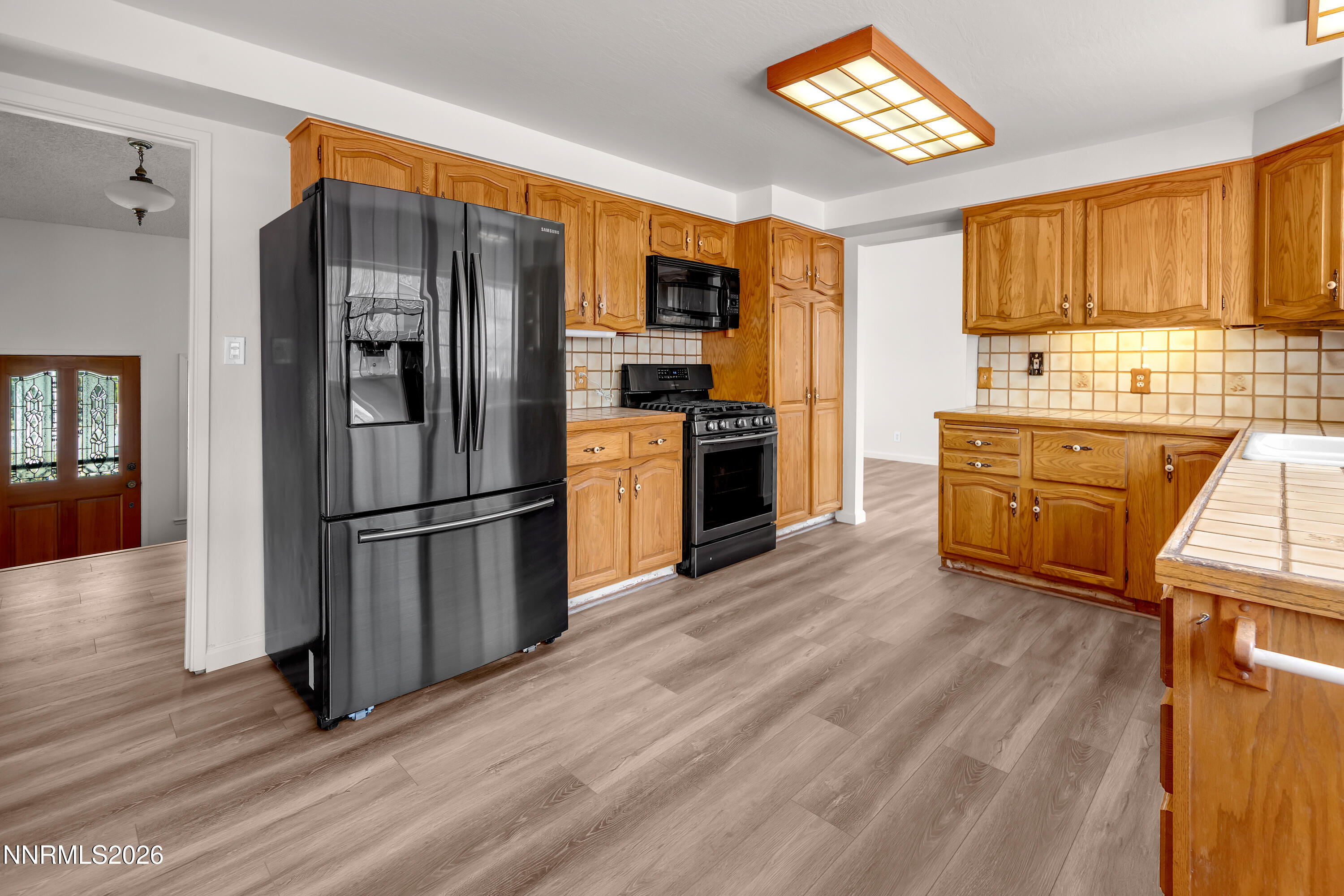 4505 Gorc Way Reno, NV 89502 - Photo 11 of 48 a kitchen with stainless steel appliances granite countertop a refrigerator microwave and stove top oven