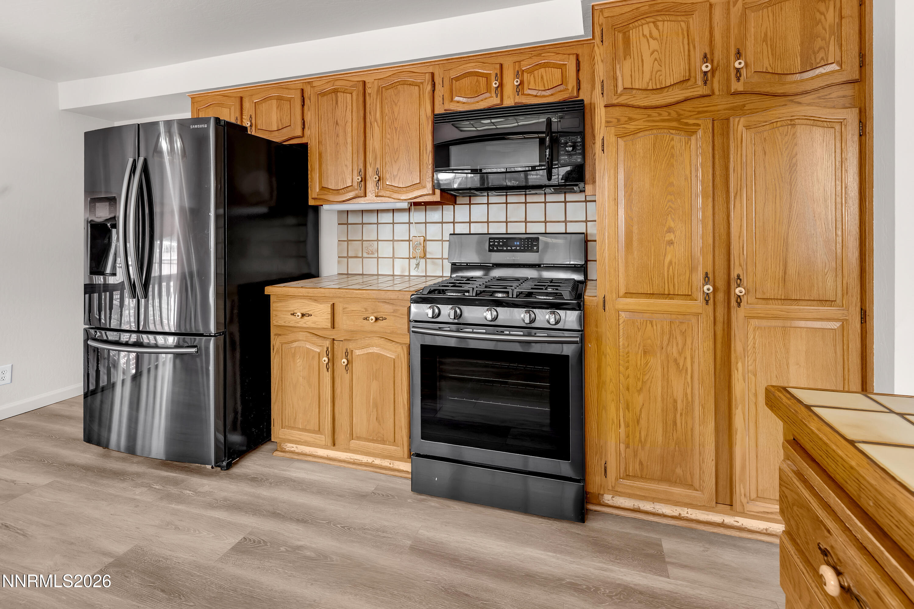 4505 Gorc Way Reno, NV 89502 - Photo 13 of 48 a kitchen with stainless steel appliances granite countertop a refrigerator stove and microwave