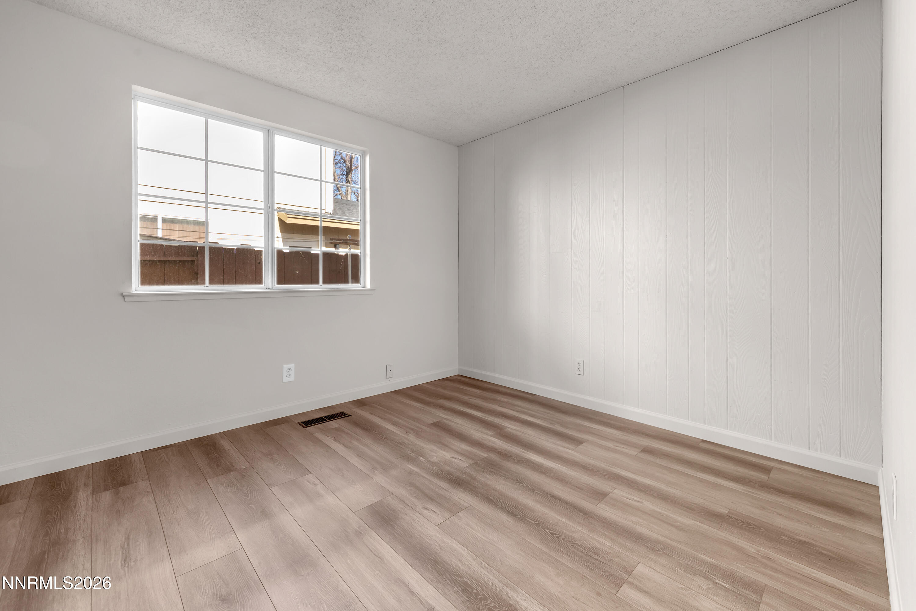 4505 Gorc Way Reno, NV 89502 - Photo 14 of 48 an empty room with wooden floor and windows