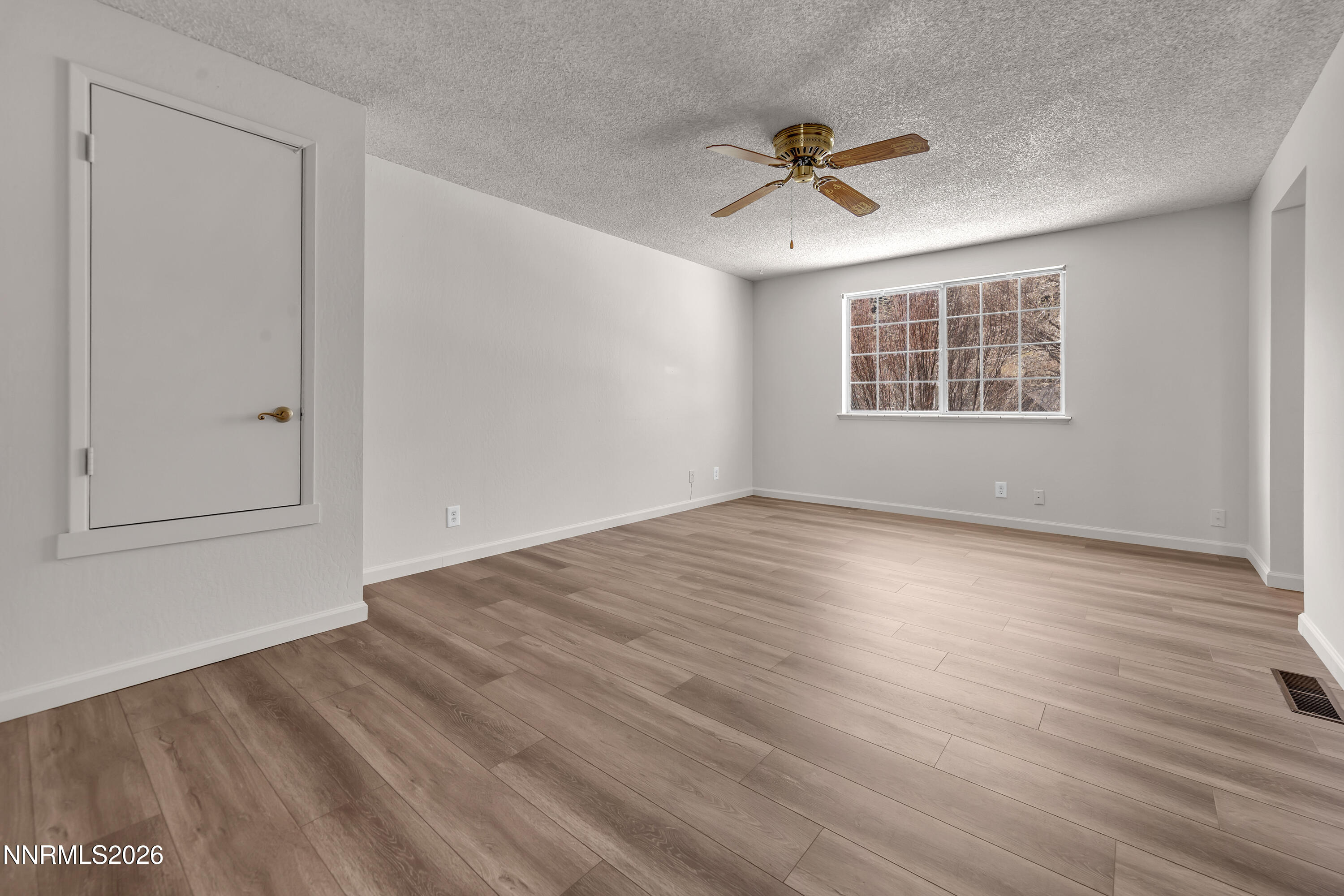 4505 Gorc Way Reno, NV 89502 - Photo 25 of 48 a view of empty room with wooden floor and ceiling fan