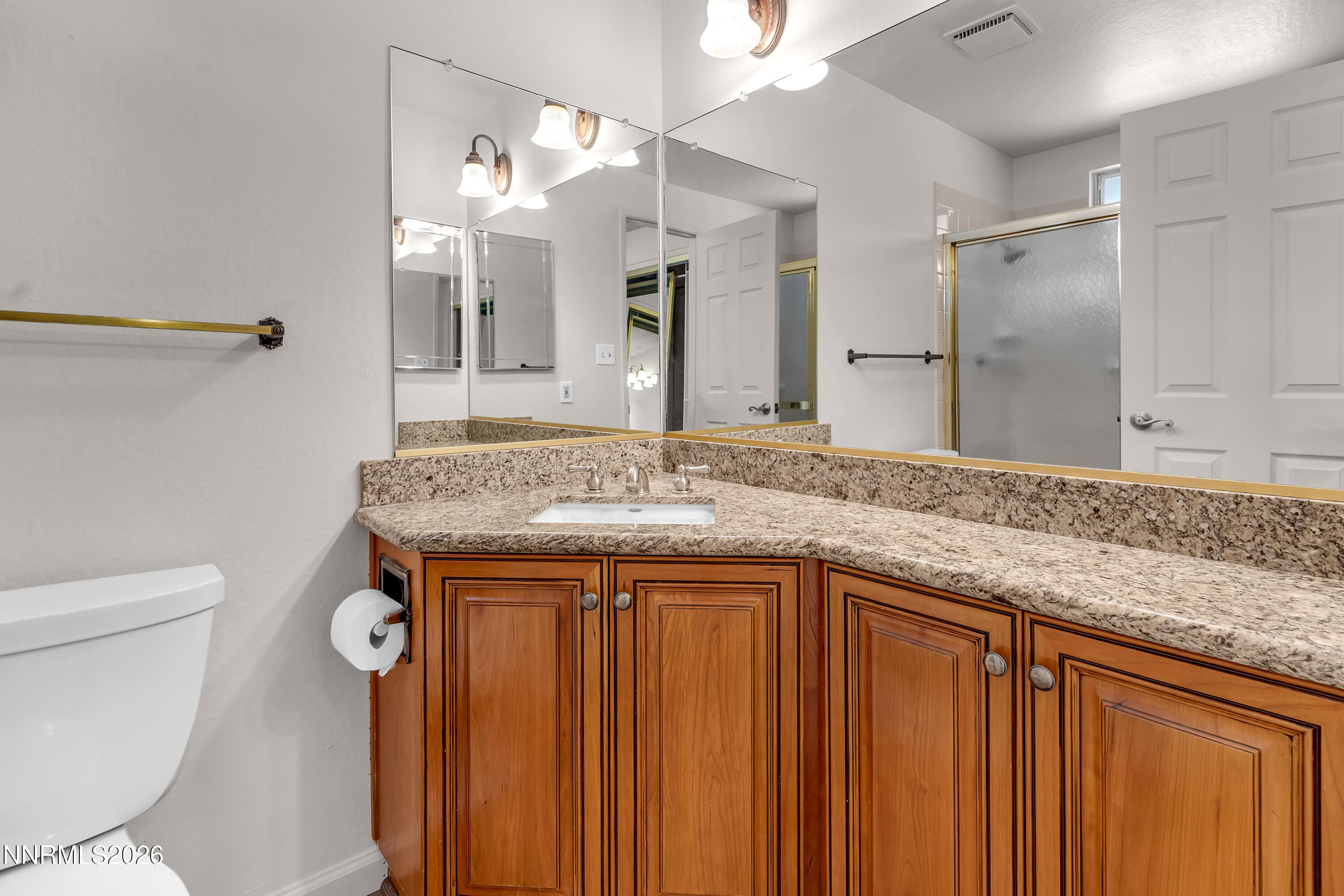 4505 Gorc Way Reno, NV 89502 - Photo 30 of 48 a bathroom with a granite countertop sink and a mirror