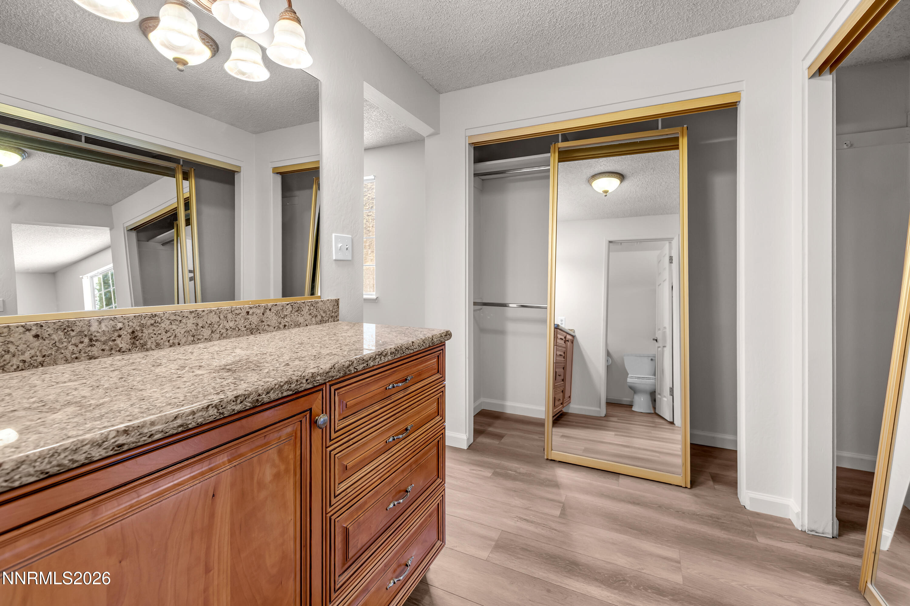 4505 Gorc Way Reno, NV 89502 - Photo 31 of 48 a bathroom with a granite countertop sink a mirror and a shower