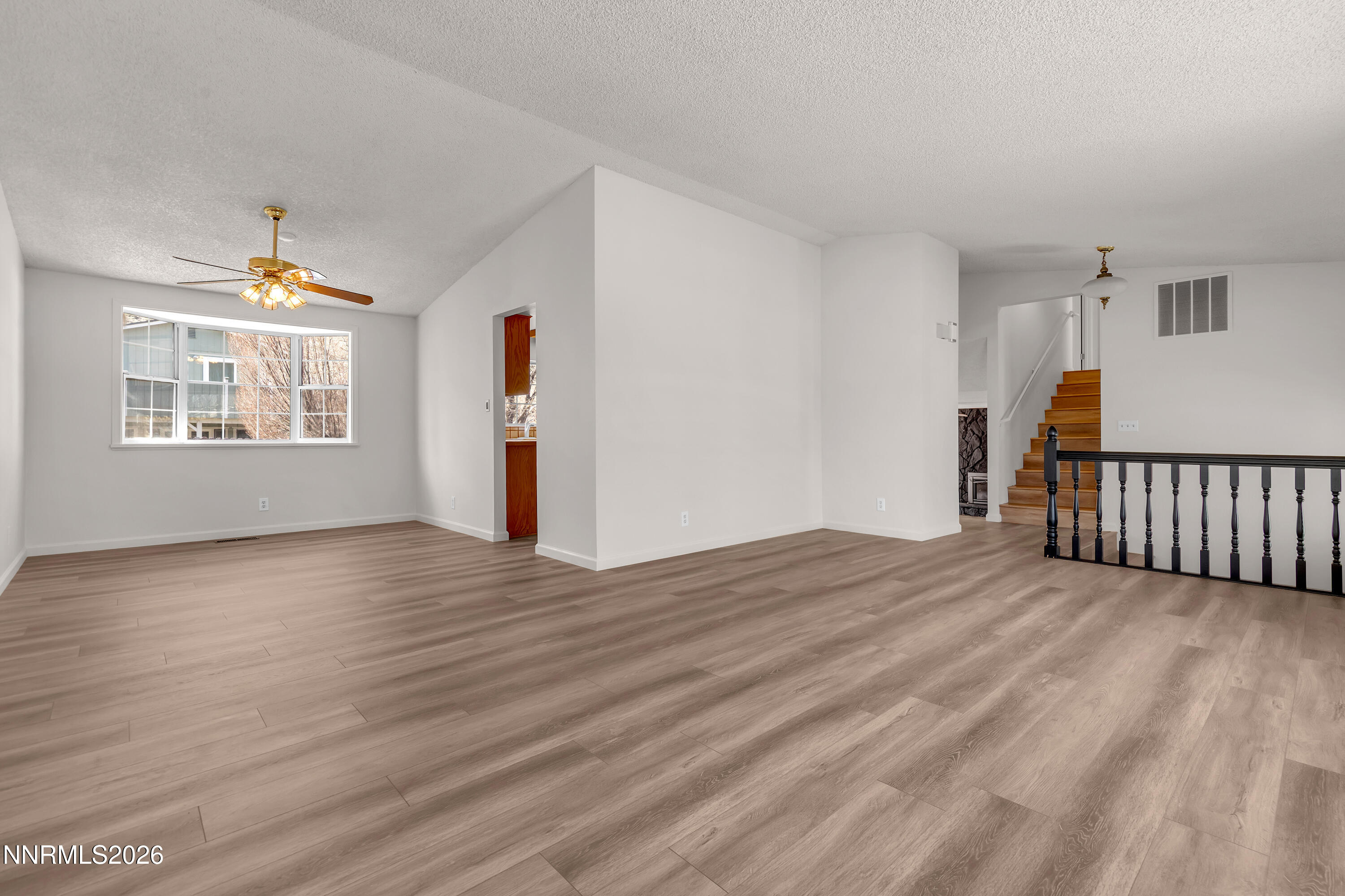 4505 Gorc Way Reno, NV 89502 - Photo 5 of 48 a view of an empty room with wooden floor and a window