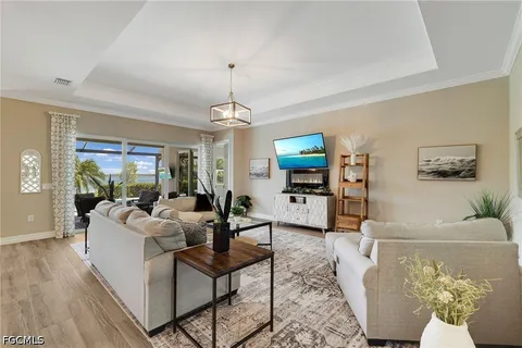 a living room with furniture and a chandelier
