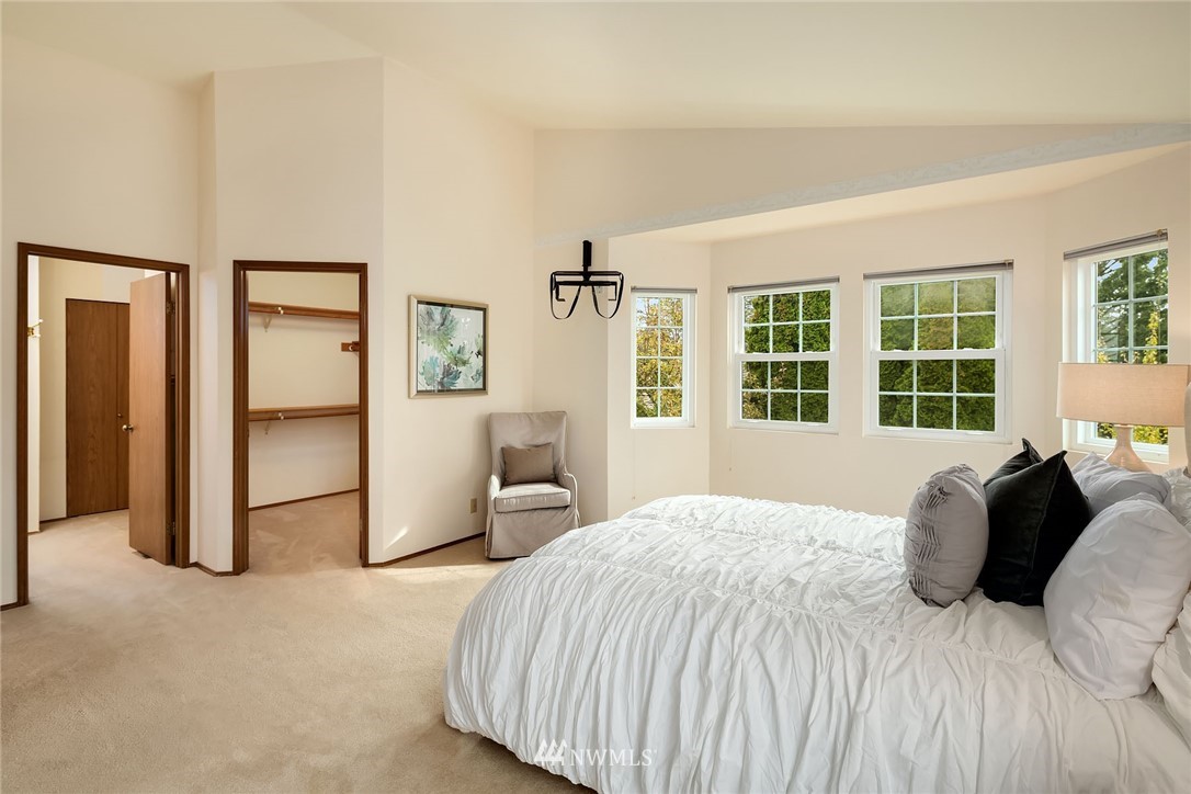 210 237th Place Southwest Bothell, WA 98021 - Photo 13 of 23 a bedroom with a bed and a large window