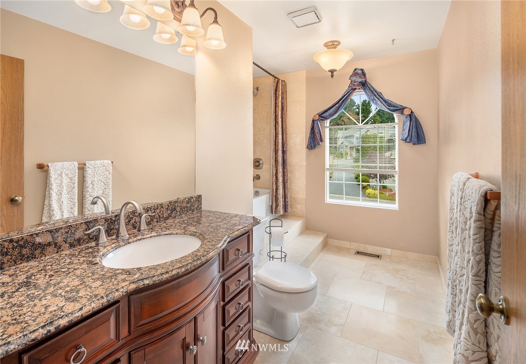 210 237th Place Southwest Bothell, WA 98021 - Photo 17 of 23 a bathroom with a granite countertop sink a toilet and mirror