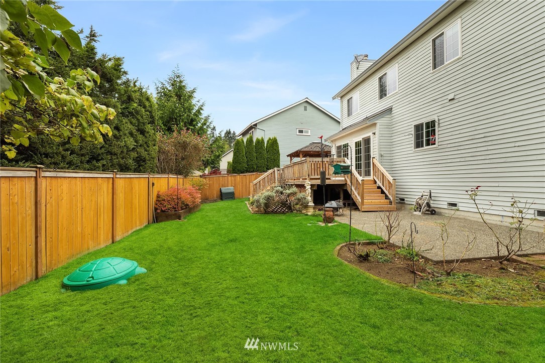 210 237th Place Southwest Bothell, WA 98021 - Photo 21 of 23 a view of a backyard with plants and a patio