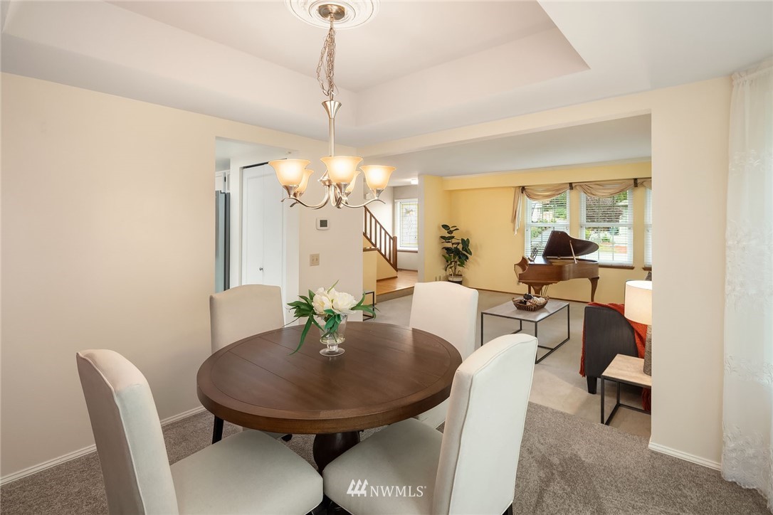 210 237th Place Southwest Bothell, WA 98021 - Photo 4 of 23 a view of a dining room with furniture a chandelier and wooden floor