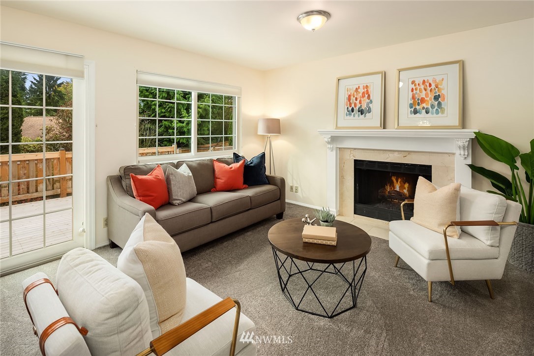 210 237th Place Southwest Bothell, WA 98021 - Photo 10 of 23 a living room with furniture a window and a fireplace