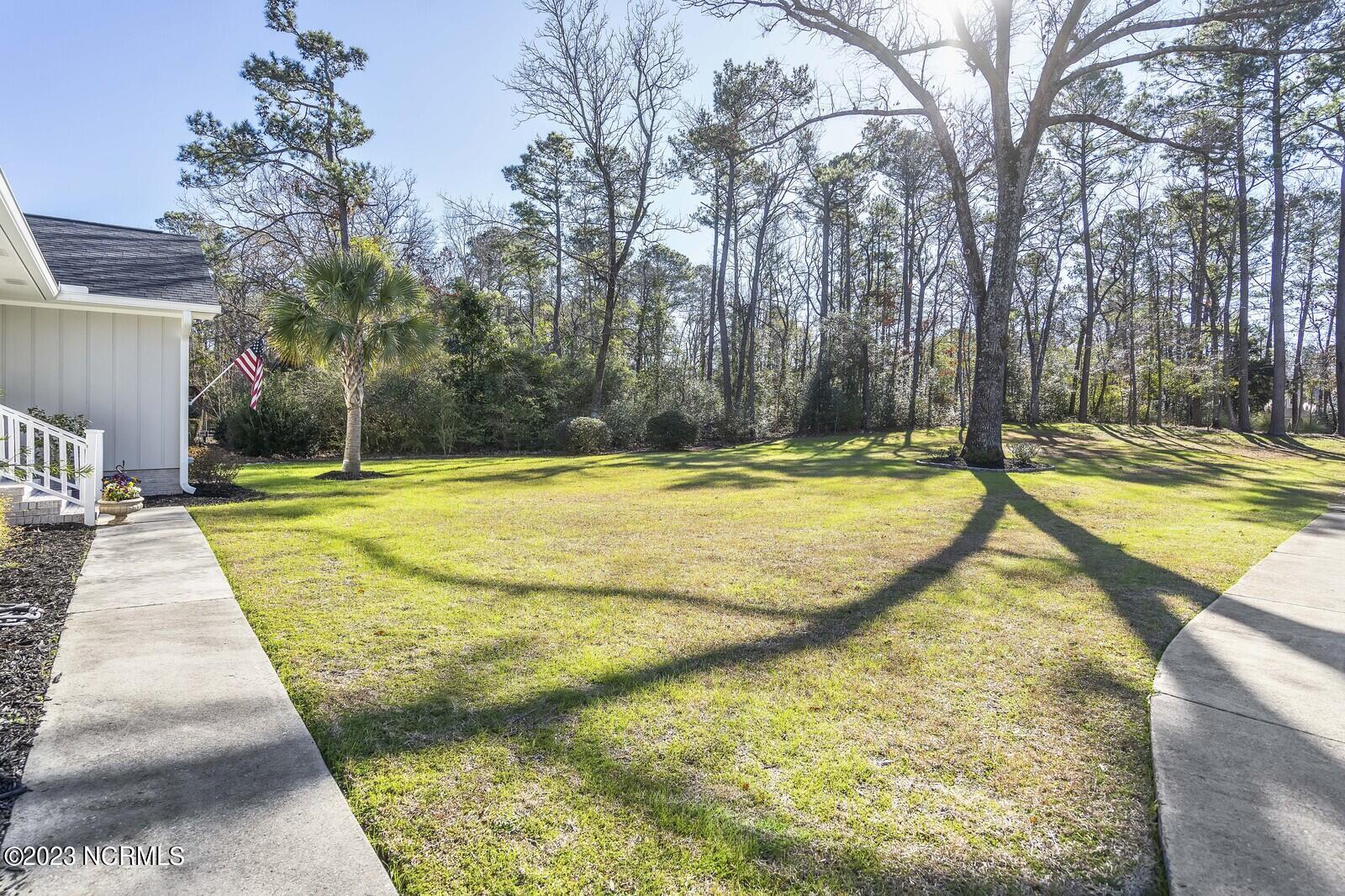 617 Porters Neck Road Wilmington, NC 28411 - Photo 2 of 47 Gorgeous mature hardwood trees and lots of landscape added