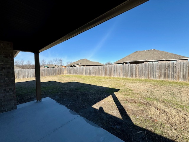 2250 Hunter Drive Pea Ridge, AR 72751 - Photo 21 of 21 Covered patio with a concrete surface, brick exterior wall, and a wood privacy fence enclosing the backyard