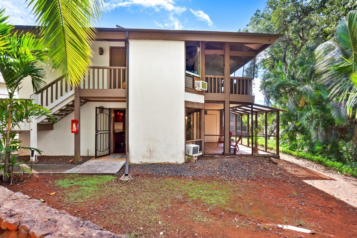 4701 Kawaihau Road, Unit L102 Kapaa, HI 96746 - Photo 1 of 22 a front view of a house with a garden