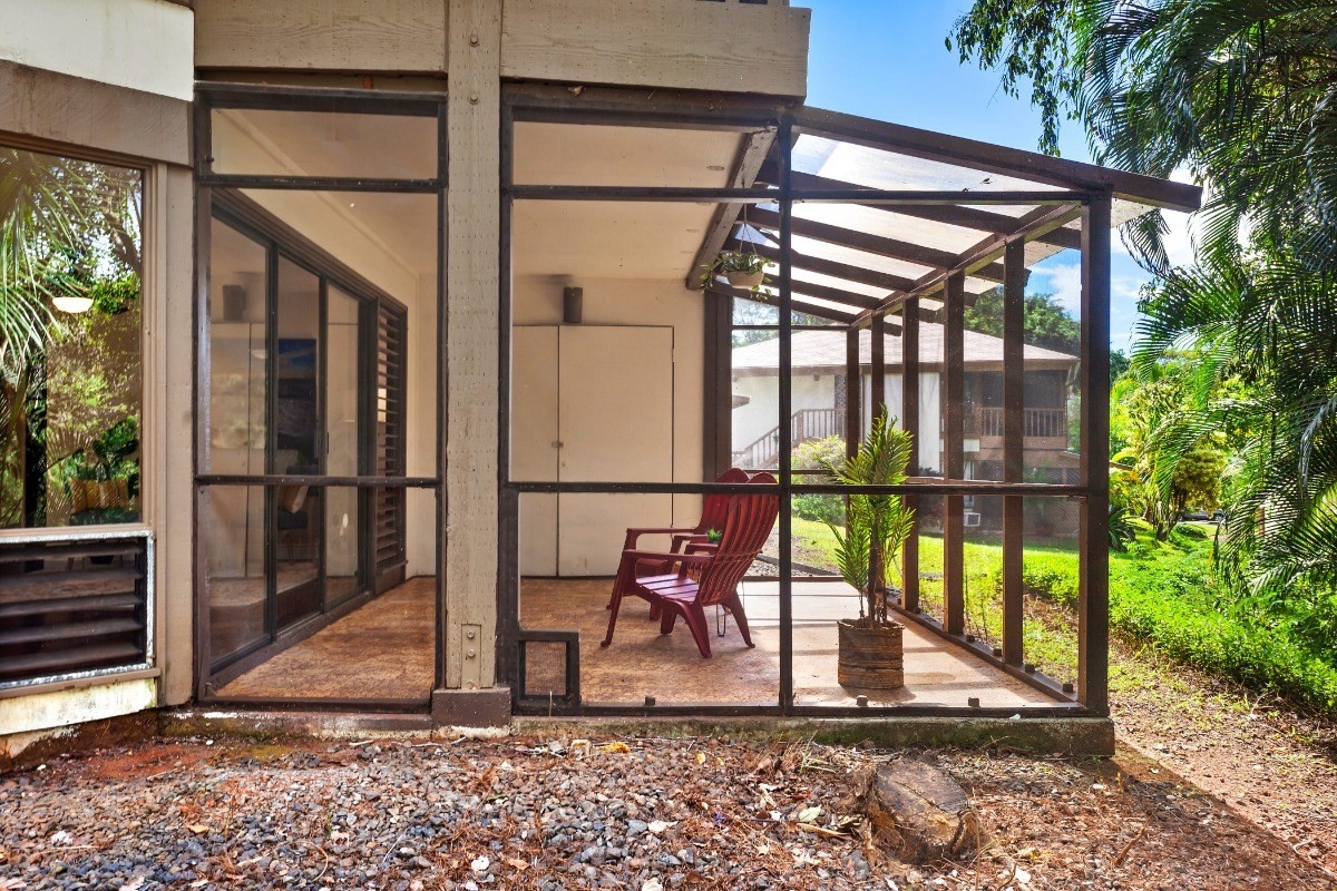 4701 Kawaihau Road, Unit L102 Kapaa, HI 96746 - Photo 5 of 22 a view of porch with a table and chairs and floor to ceiling window