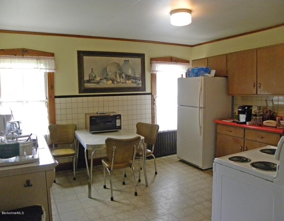 128 North Green River Road Colrain, MA 01340 - Photo 5 of 15 a kitchen with furniture a refrigerator and a dining table
