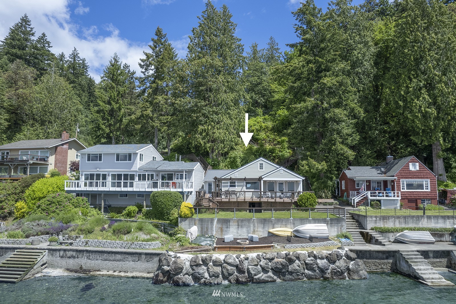 a front view of a residential houses with yard and green space