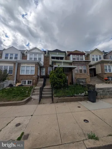 a front view of a residential apartment building with a yard
