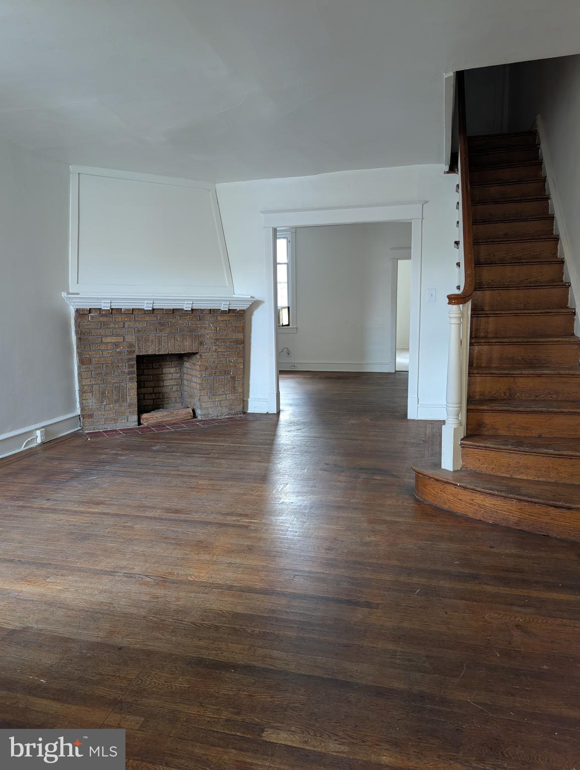 5927 Springfield Avenue Philadelphia, PA 19143 - Photo 2 of 17 wooden floor fireplace and natural light