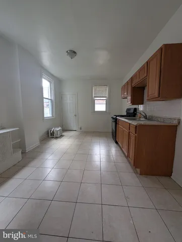 a kitchen with stainless steel appliances a sink a stove a microwave and cabinets