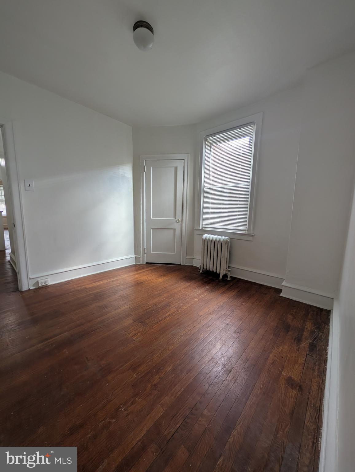 5927 Springfield Avenue Philadelphia, PA 19143 - Photo 9 of 17 an empty room with wooden floor and windows