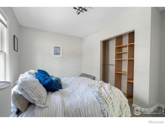 a bedroom with a bed and a cabinet