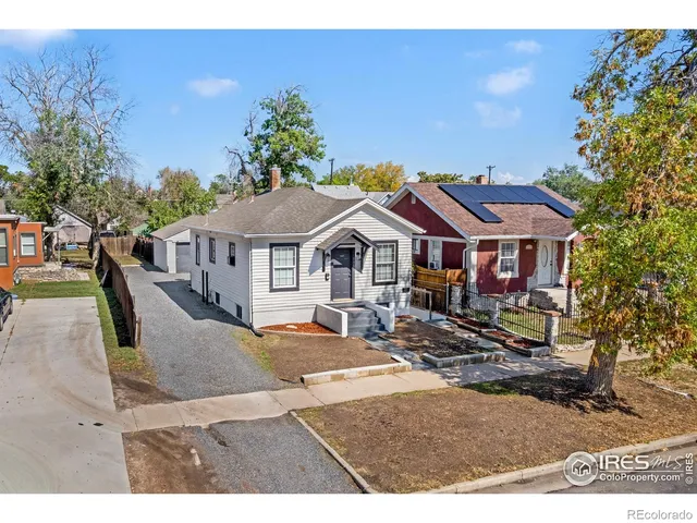 a view of a house with backyard porch and sitting area