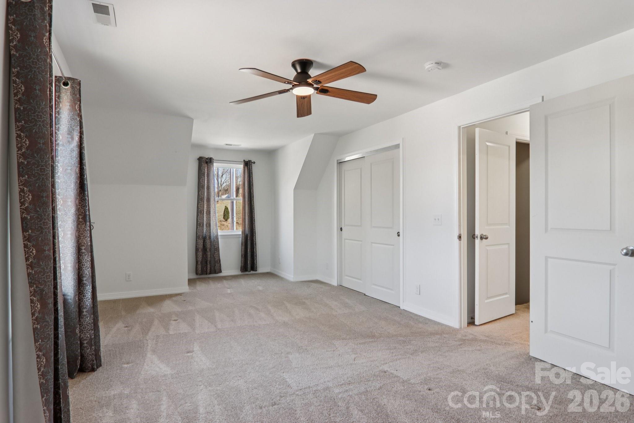 751 Hutch Mountain Road Fletcher, NC 28732 - Photo 34 of 48 a view of empty room with ceiling fan