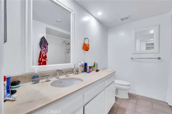a bathroom with a sink mirror and toilet