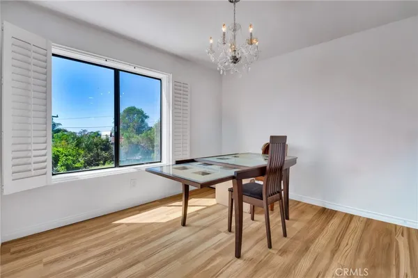 a room with a table wooden floor and a window