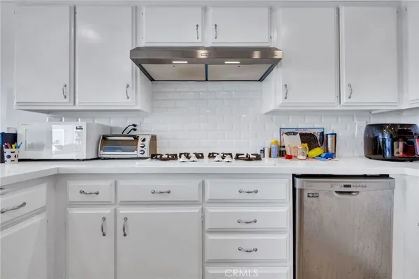 a kitchen with stainless steel appliances granite countertop a sink and cabinets