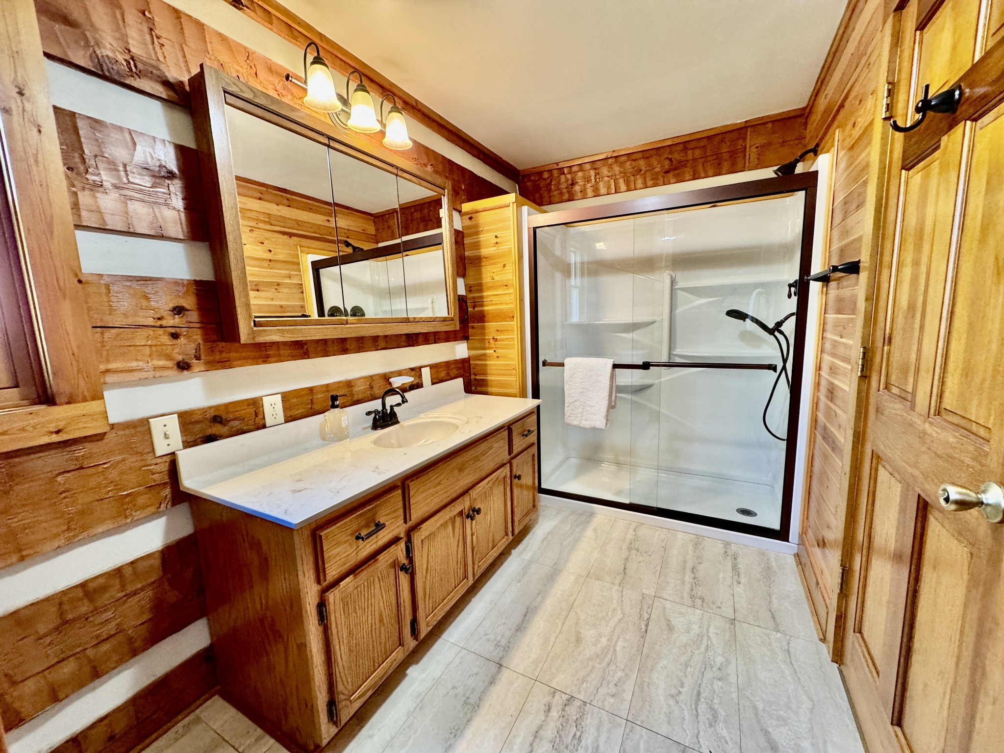 1342 Aetna Church Road Centerville, TN 37033 - Photo 28 of 59 a bathroom with a sink a mirror and a shower