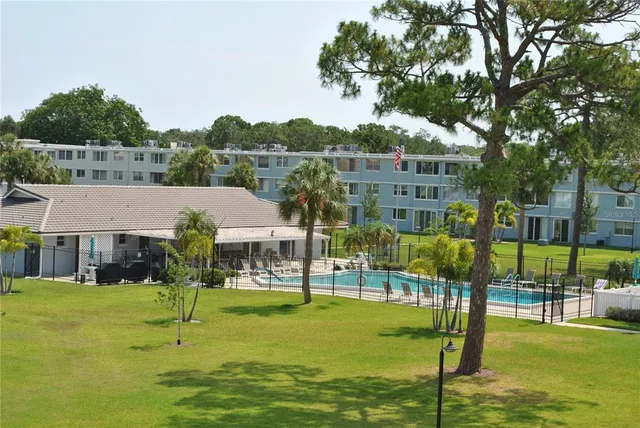 a view of a swimming pool and a yard