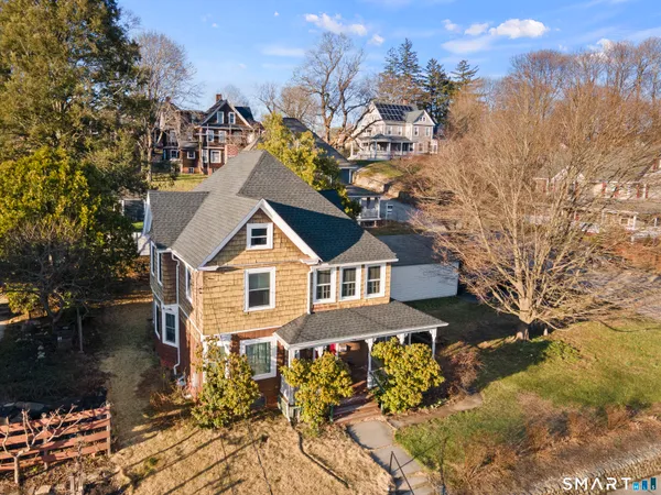 a big house with a big yard and large trees