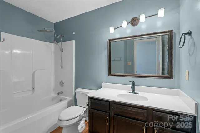 a bathroom with a sink vanity toilet and shower
