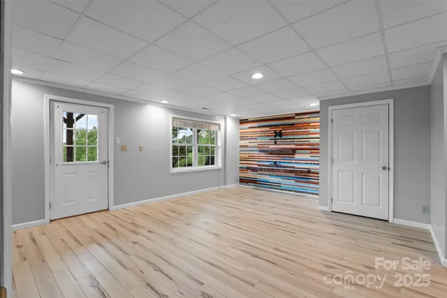 a view of room with wooden floor and window