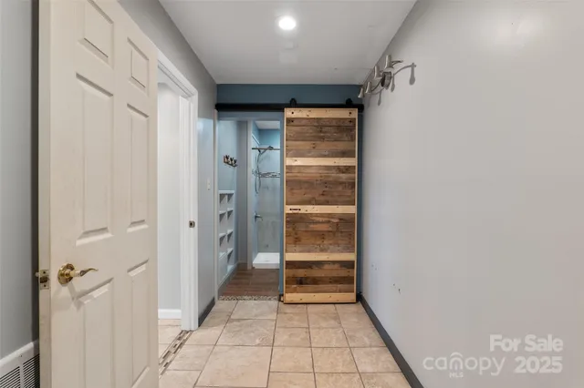 a view of a hallway with closet and stairs