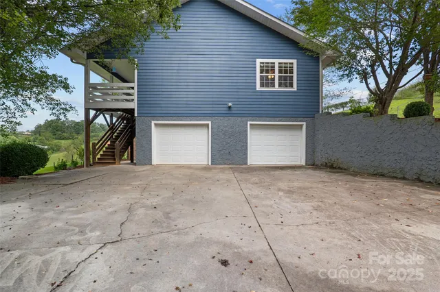 a view of a house with a yard and garage