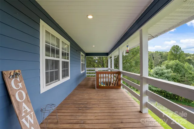 a view of roof deck with wooden floor and floor to ceiling window