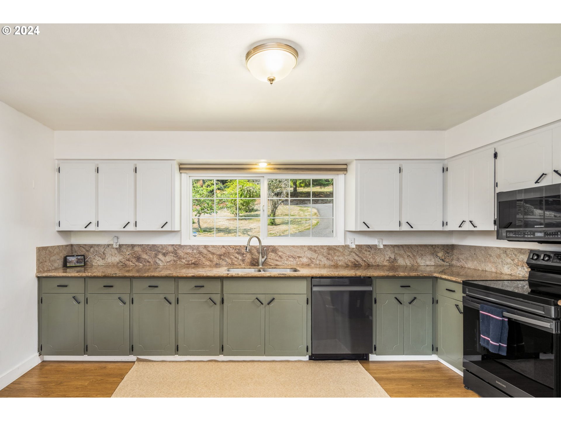 13762 Southeast Wiese Road Damascus, OR 97089 - Photo 11 of 44 a kitchen with stainless steel appliances granite countertop a stove a sink and a granite counter tops
