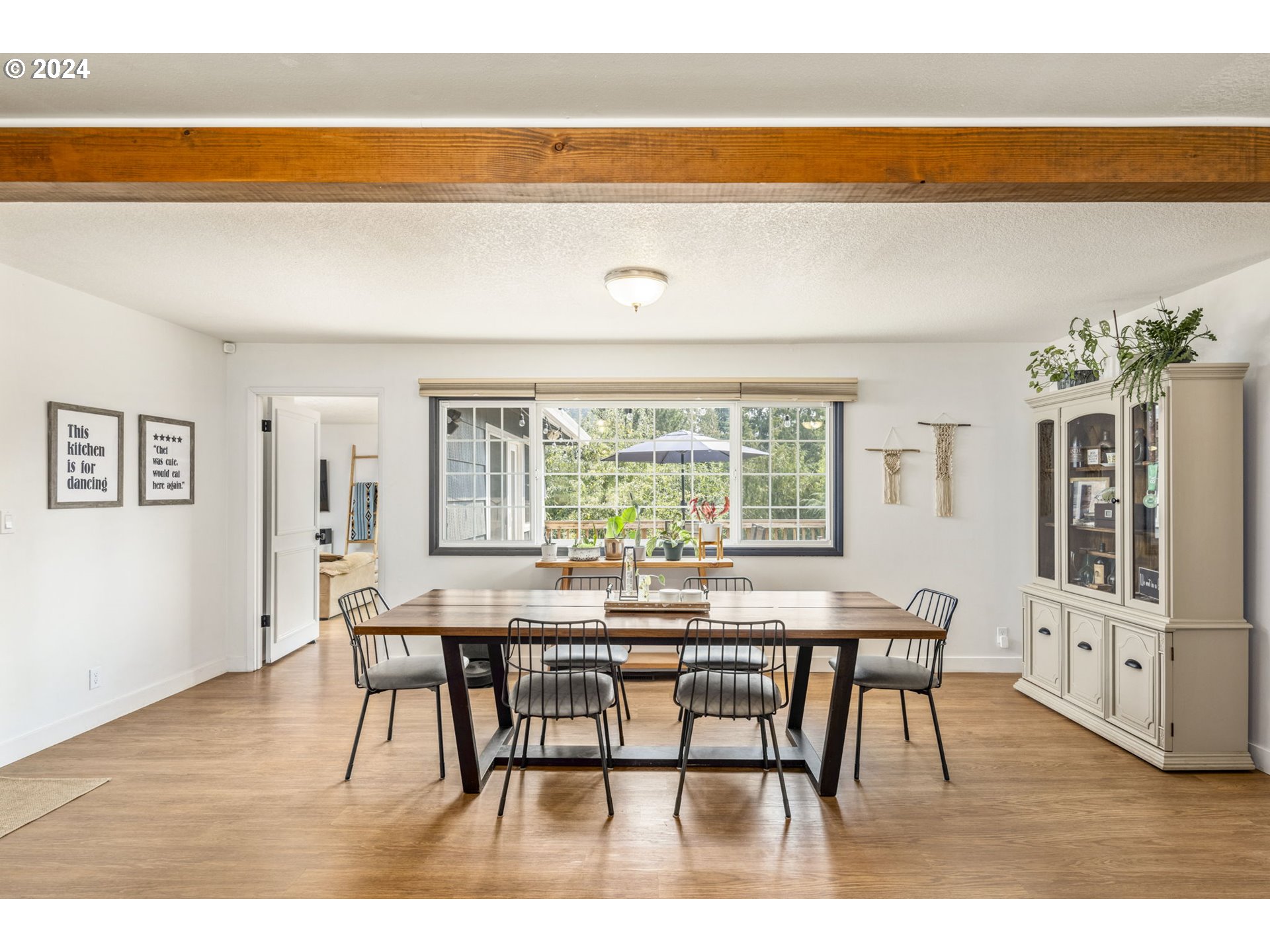 13762 Southeast Wiese Road Damascus, OR 97089 - Photo 13 of 44 a view of a dining room with furniture window and wooden floor