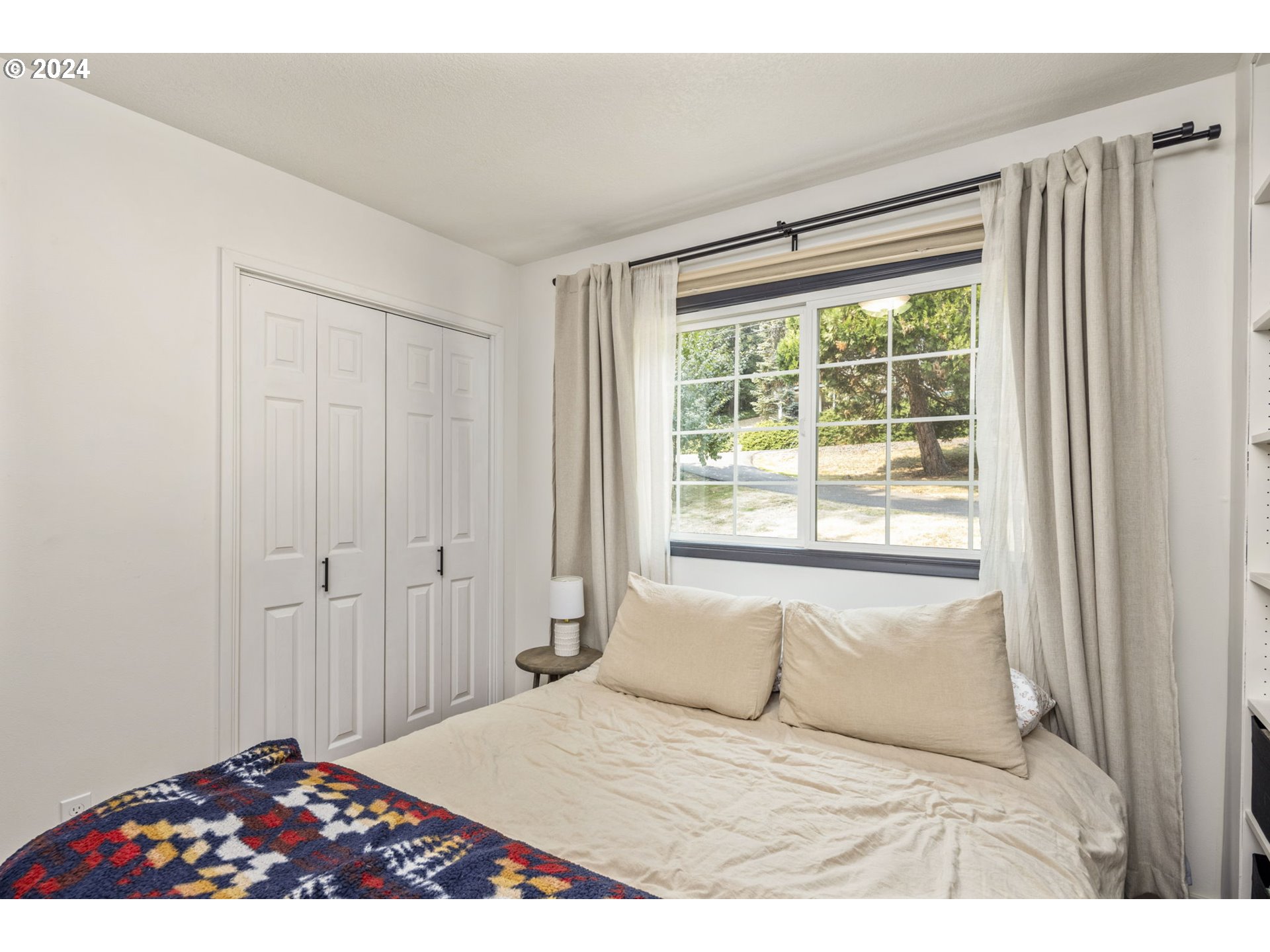 13762 Southeast Wiese Road Damascus, OR 97089 - Photo 23 of 44 a bedroom with a large bed and a window