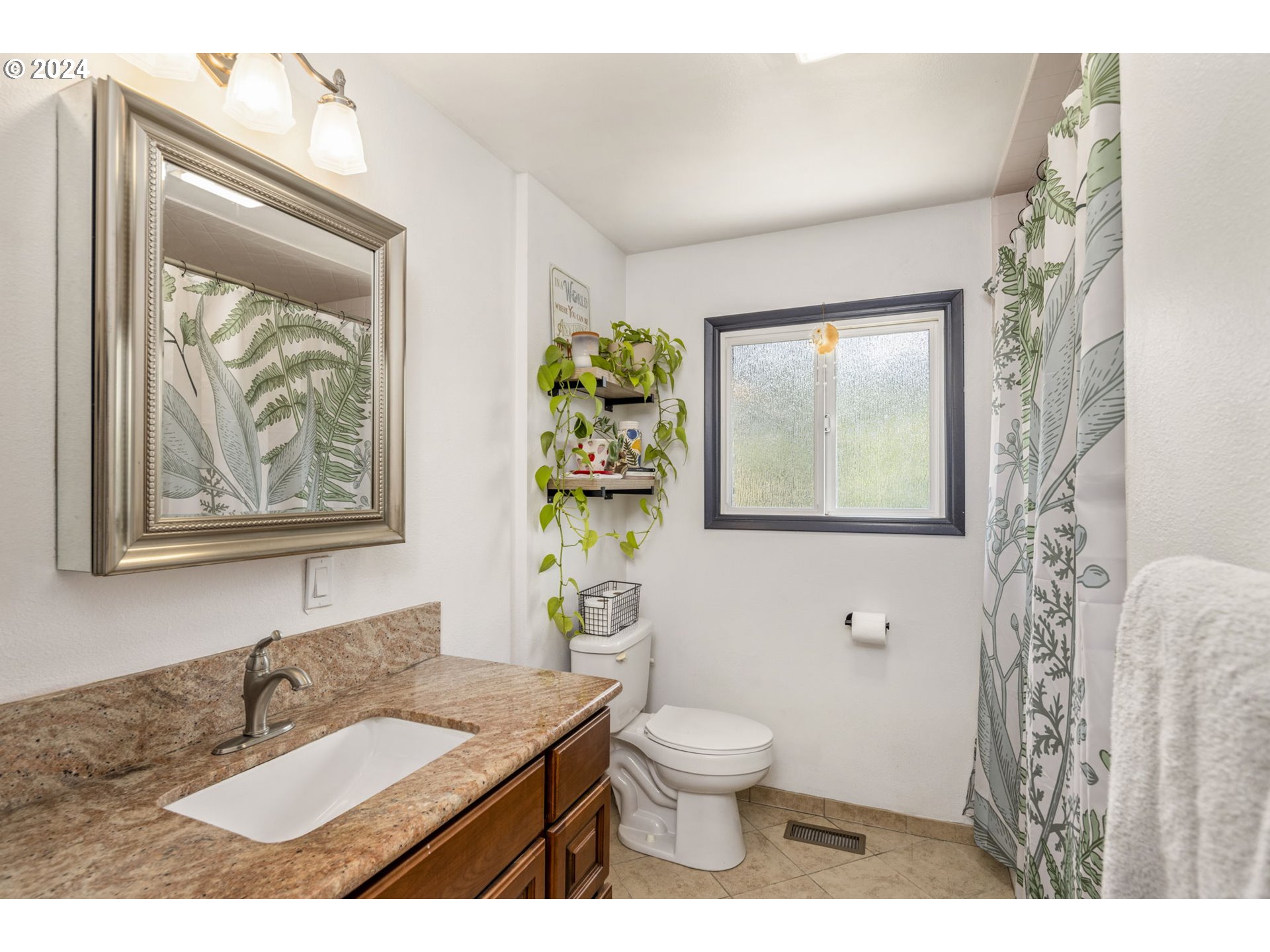13762 Southeast Wiese Road Damascus, OR 97089 - Photo 24 of 44 a bathroom with a granite countertop sink a toilet and a window