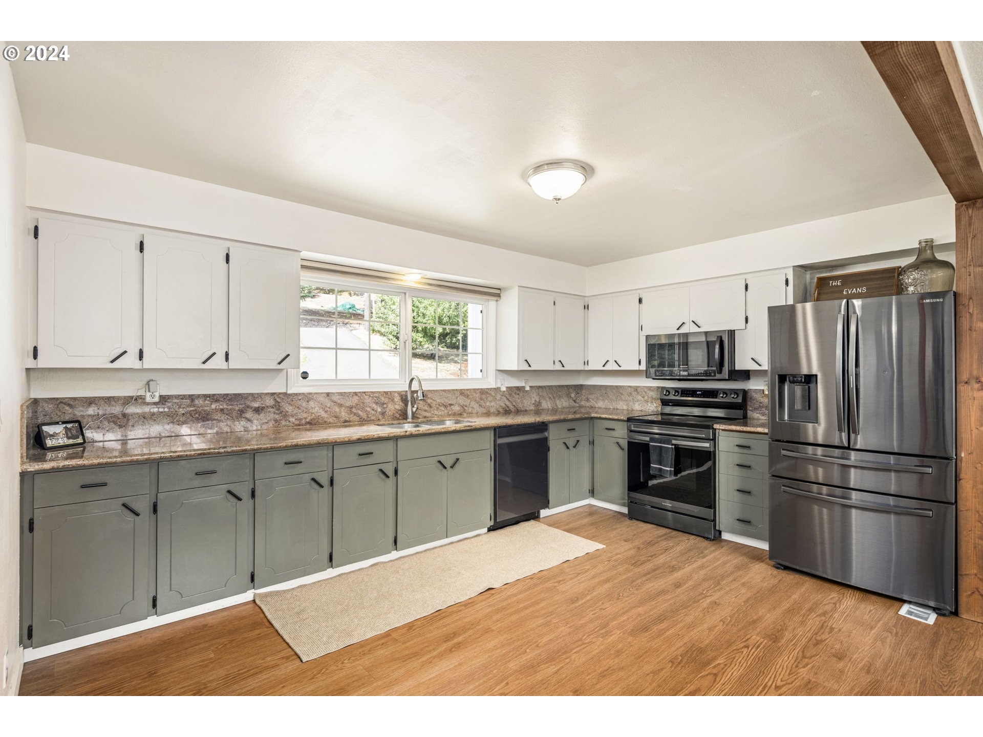 13762 Southeast Wiese Road Damascus, OR 97089 - Photo 10 of 44 a kitchen with granite countertop a refrigerator stove top oven and sink
