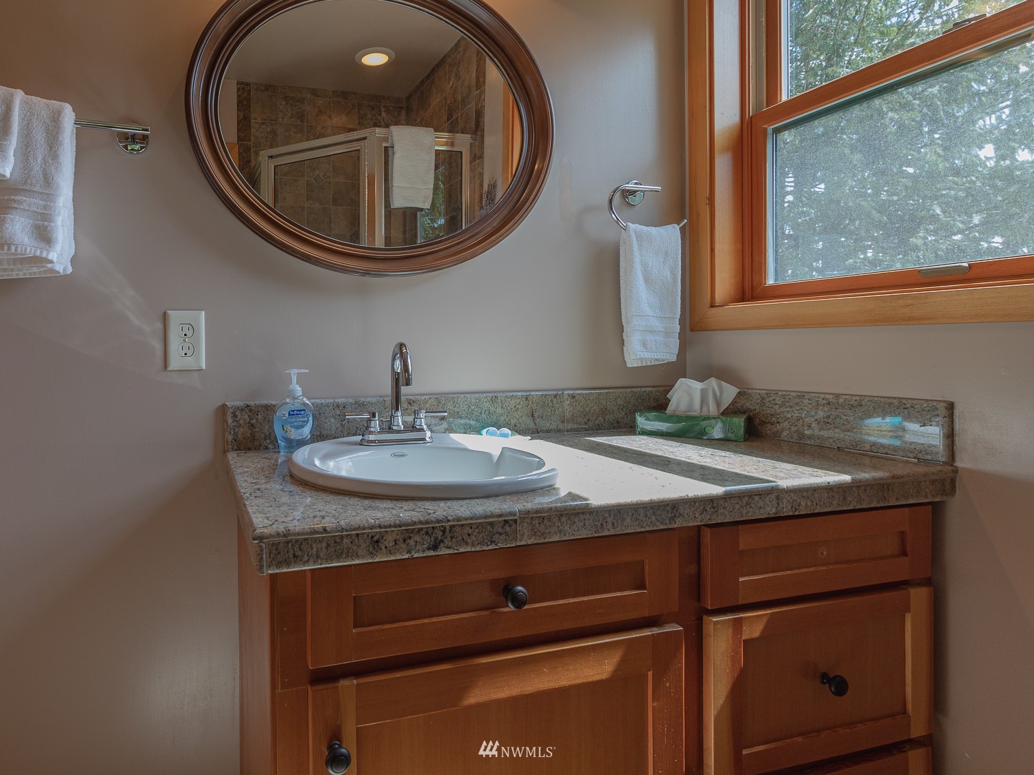 1864 Lost Mountain Road Sequim, WA 98382 - Photo 17 of 35 a bathroom with a granite countertop sink and a mirror