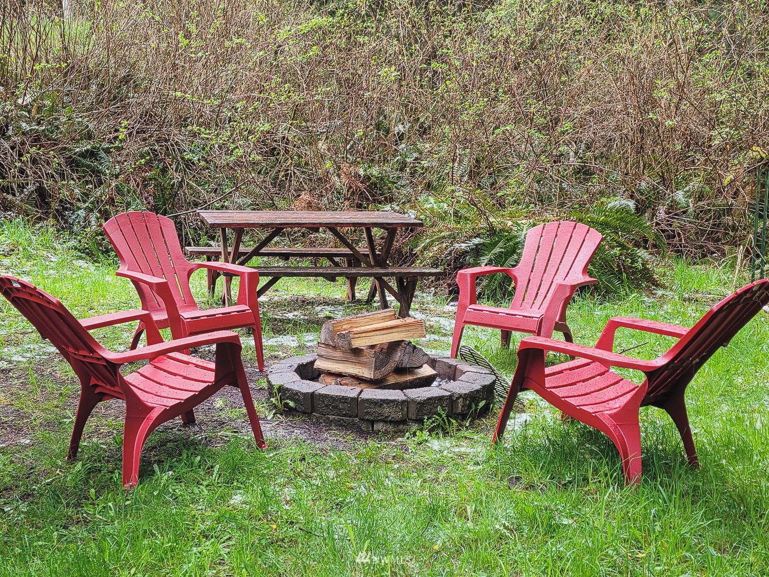 1864 Lost Mountain Road Sequim, WA 98382 - Photo 23 of 35 a backyard of a house with table and chairs