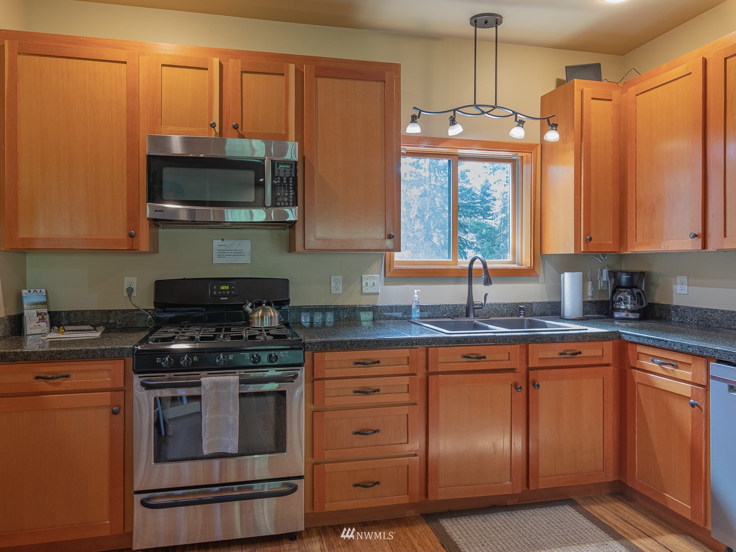1864 Lost Mountain Road Sequim, WA 98382 - Photo 10 of 35 a kitchen with stainless steel appliances granite countertop a sink stove and microwave