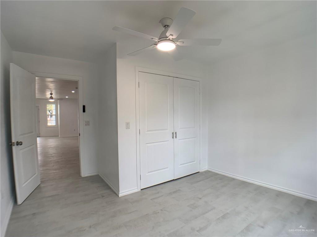 10824 Compadres Street Mercedes, TX 78570 - Photo 12 of 19 an empty room with a white walls and ceiling fan