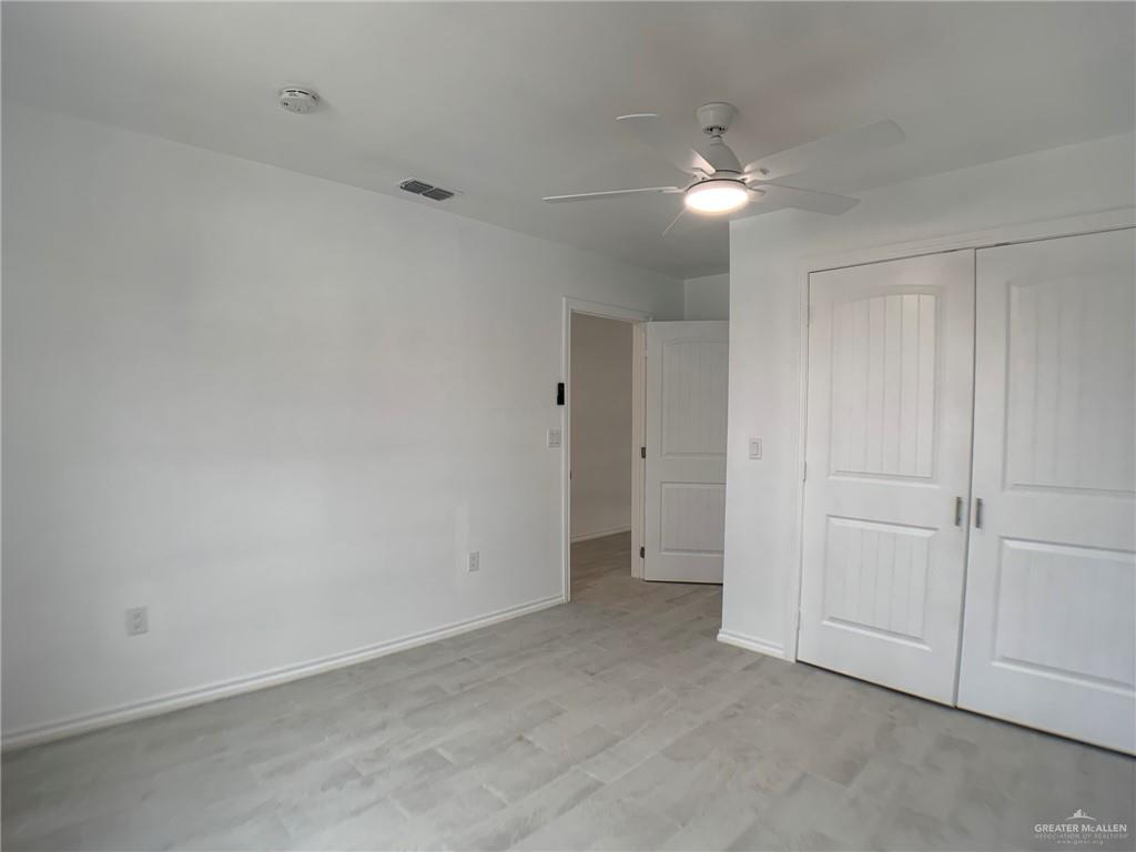 10824 Compadres Street Mercedes, TX 78570 - Photo 13 of 19 wooden floor in an empty room