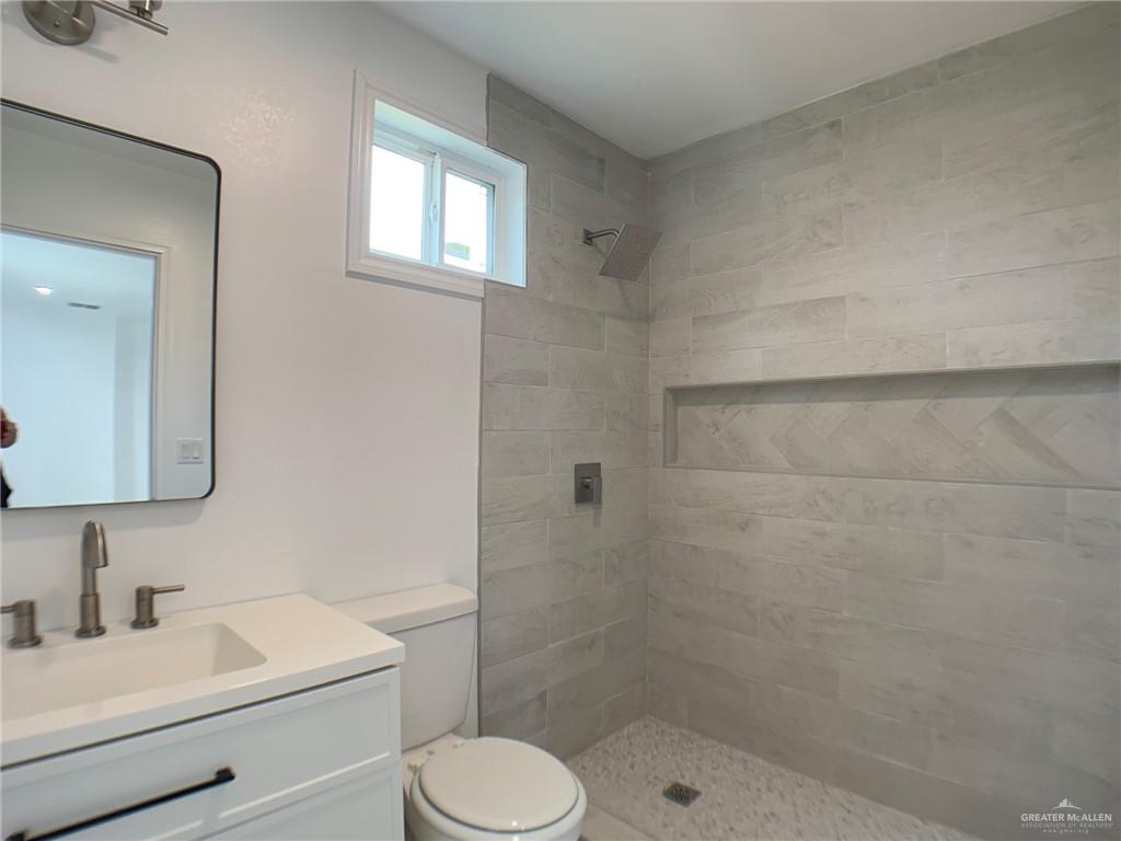 10824 Compadres Street Mercedes, TX 78570 - Photo 16 of 19 a bathroom with a sink a toilet and shower
